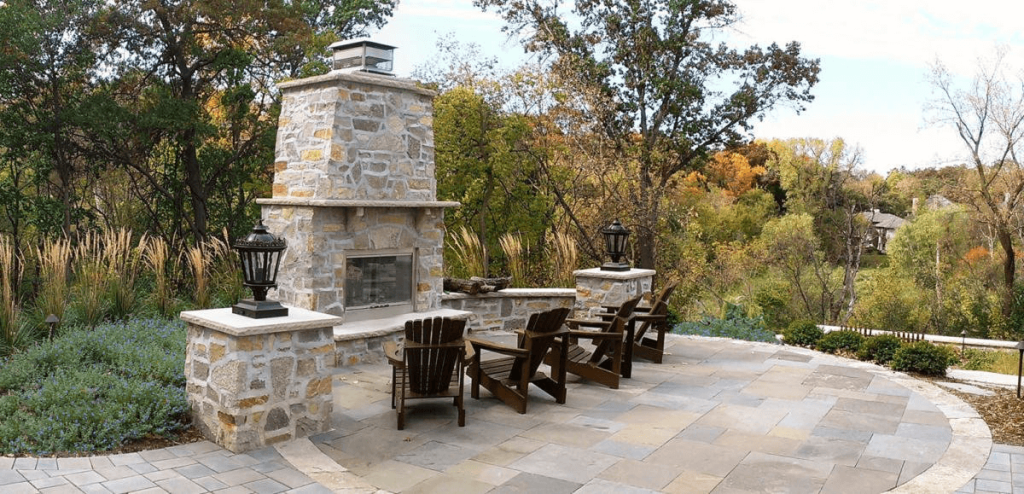 Custom outdoor kitchen and fireplace in Twin Cities backyard