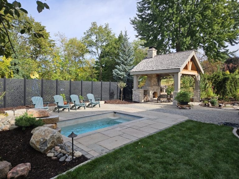 Beautiful plunge pool, patio and outdoor pavilion with kitchen and fireplace. Making the most of your smaller footprint yard.